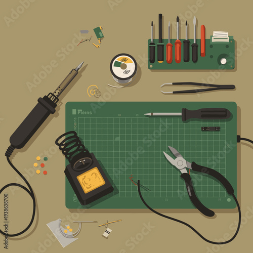 A top-down view of a workbench with electronics soldering tools and components laid out on a green cutting mat.