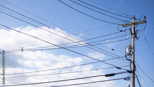 Electrical Power Lines and Utility Pole Against Blue Sky