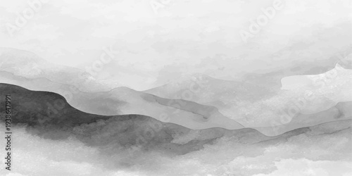 A majestic misty mountain landscape unfolds under a dark storm sky where white clouds and thick fog drift over snow-capped peaks at sunset, creating a dramatic winter nature view for travel