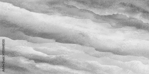 A textured closeup of white snow and frozen ice patterns on cold mountains under a blue winter sky with clouds creates an abstract nature background