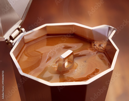 Freshly brewed coffee in italian moka pot seen from above