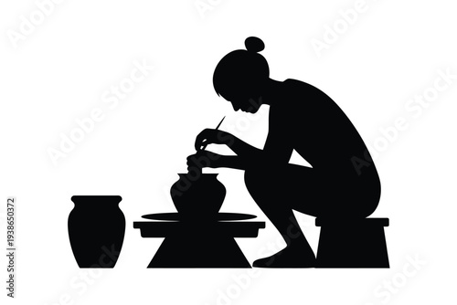 Silhouette of a potter working at a wheel with finished pottery