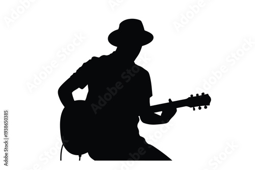 Silhouette of a musician playing an acoustic guitar in profile