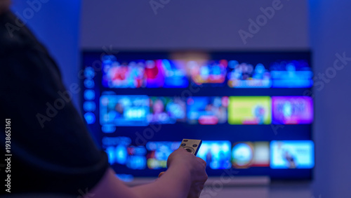 Person using remote to browse streaming apps on smart tv