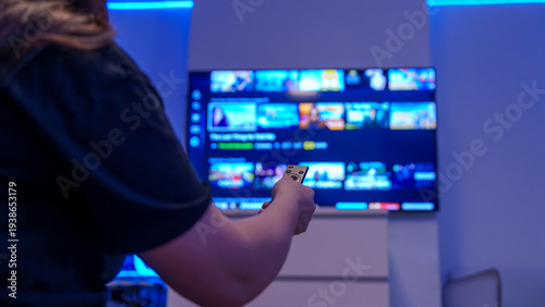 Canvastavla Remote control streaming on smart tv in blue lit living room