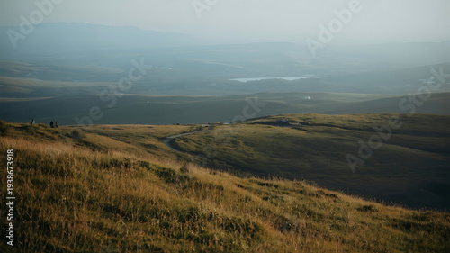 Wallpaper Mural Vast, rolling hills meet a hazy horizon, evoking a sense of solitude and expansive natural beauty. Torontodigital.ca