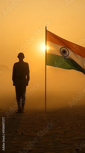 Silhouette of soldier standing by Indian flag at sunset