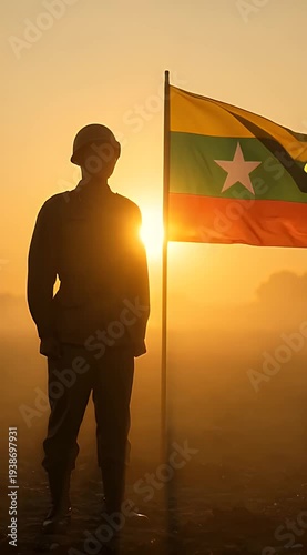 Silhouette of Soldier with Myanmar Flag at Sunrise
