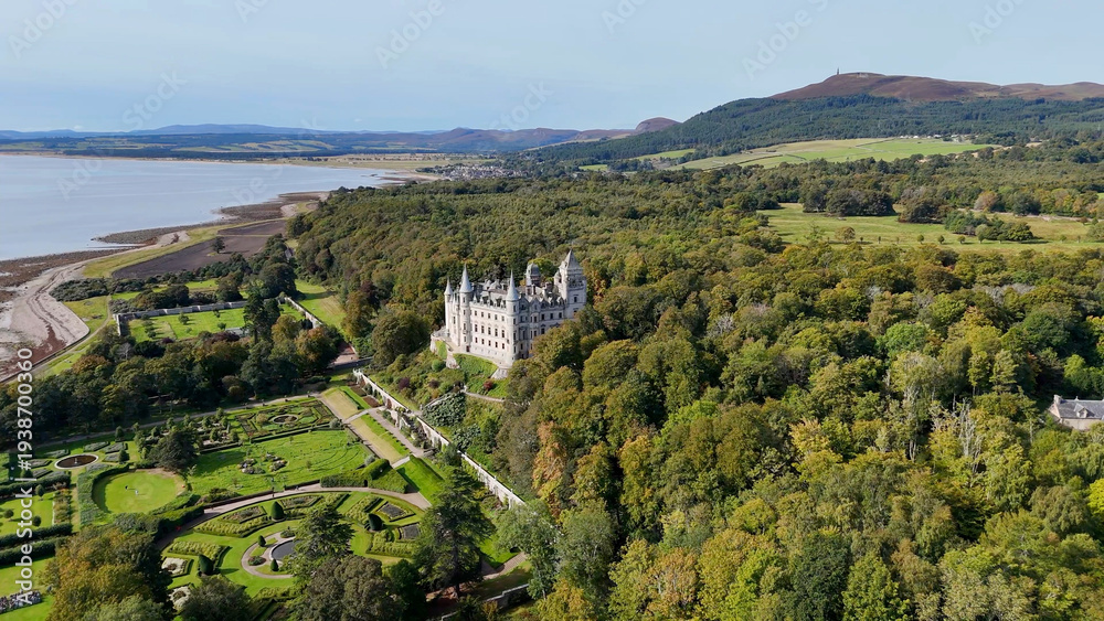 Naklejka premium Magnificent Aerial View of Dunrobin Castle Architecture, a Historic French Châteaux Style Estate with Iconic Turrets and Spires in the Heart of the Scottish Highlands, Sutherland, UK.