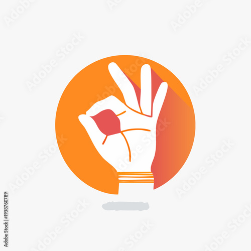 Hand gesture showing okay sign in front of orange circle.