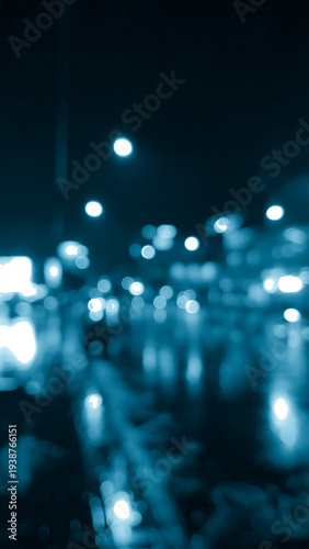 Blurred tranquil dreamy night city road at rain times in cyan blue tone