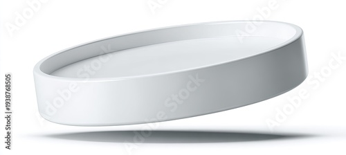 A smooth, white, circular dish floats above a white surface