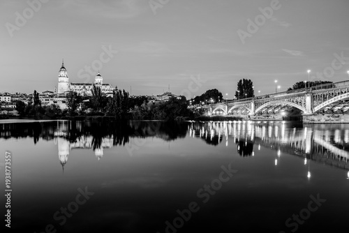 Salamanca, Castilla and Leon, Spain: Twilight view of Salamanca Cathedral and Enrique Estevan Bridge reflected in the waters of river Tormes; the Old Cathedral, Cathedral of Santa Maria