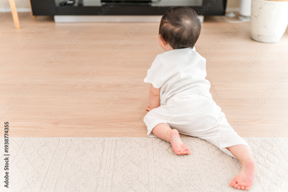 Naklejka premium Baby crawling in the living room at home