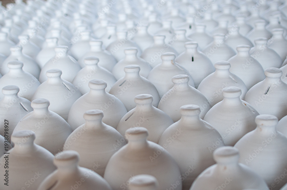 Obraz premium Bahrain’s traditional A’ali hand-crafted pottery. Collection of white jugs ready for the kiln.