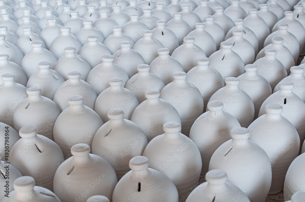 Fototapeta premium Bahrain’s traditional A’ali hand-crafted pottery. White clay jugs drying.