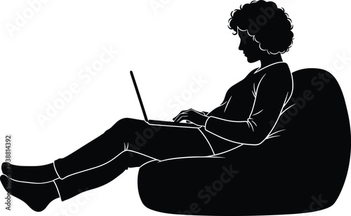 Black silhouette of young woman with curly hair working on laptop while sitting in comfortable bean bag chair isolated on white background for freelance concept