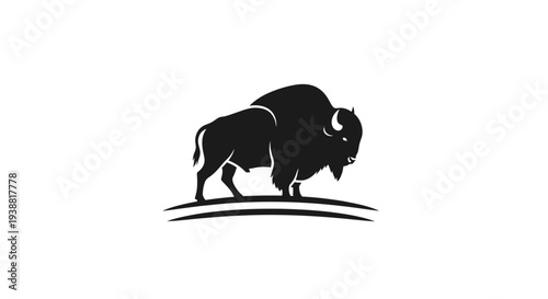 Black silhouette of a bison walking.