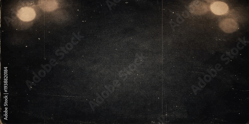 A dark grunge film background features an old textured concrete wall with a vintage black chalkboard surface and aged paper patterns to create an empty antique backdrop