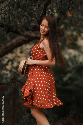 Young girl in retro dress posing in nature.