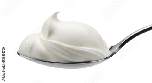 Swirl of creamy white yogurt on a spoon, isolated.