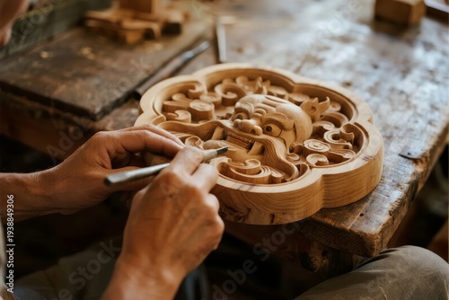 Artisan carving intricate wooden relief with chisel on workshop table
