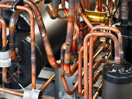 Copper pipelines form intricate networks in industrial refrigeration systems at a facility