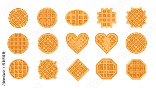 Collection of fifteen golden brown waffles in various shapes like round heart square and octagon arranged on a white background.