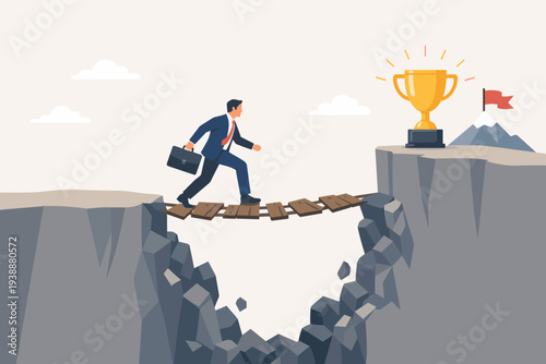 Businessman crossing a precarious wooden bridge over a deep chasm to reach a golden trophy, symbolizing risk, challenge, determination, ambition, and the difficult path to career success.
