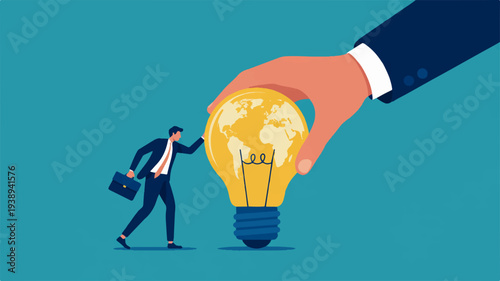 Businessman approaches glowing light bulb held by giant hand in blue background