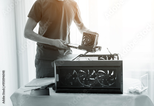 Man assembling a desktop computer in a bright airy workspace