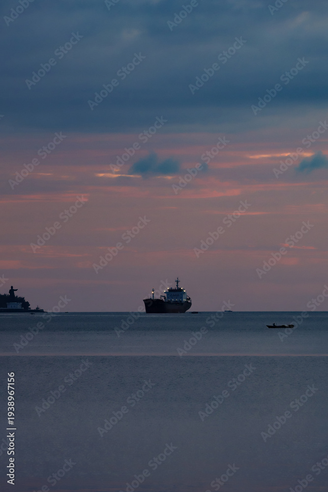Fototapeta premium beautiful view in the afternoon with a view of the ocean and islands with an orange sky after sunset. beautiful view suitable for wallpaper or background