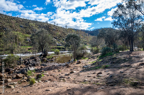 Rocky riverbed and rapids framed by eucalypts in Bells Rapids Park, Swan Valley, Australia, 2 June 2021