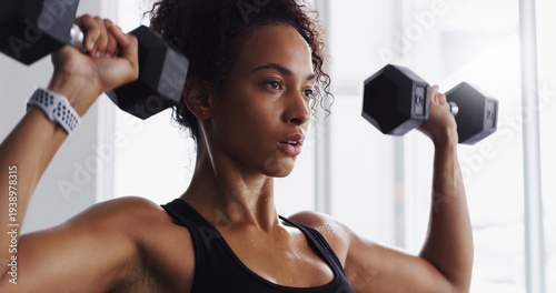 Fotografie Sweaty, dumbbells or woman in gym for workout, strength training or endurance challenge for bicep growth