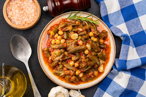 Freshly cooked okra dish on black stone table background
