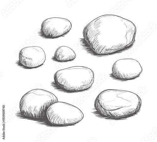 Black and white of smooth pebbles scattered a white stones