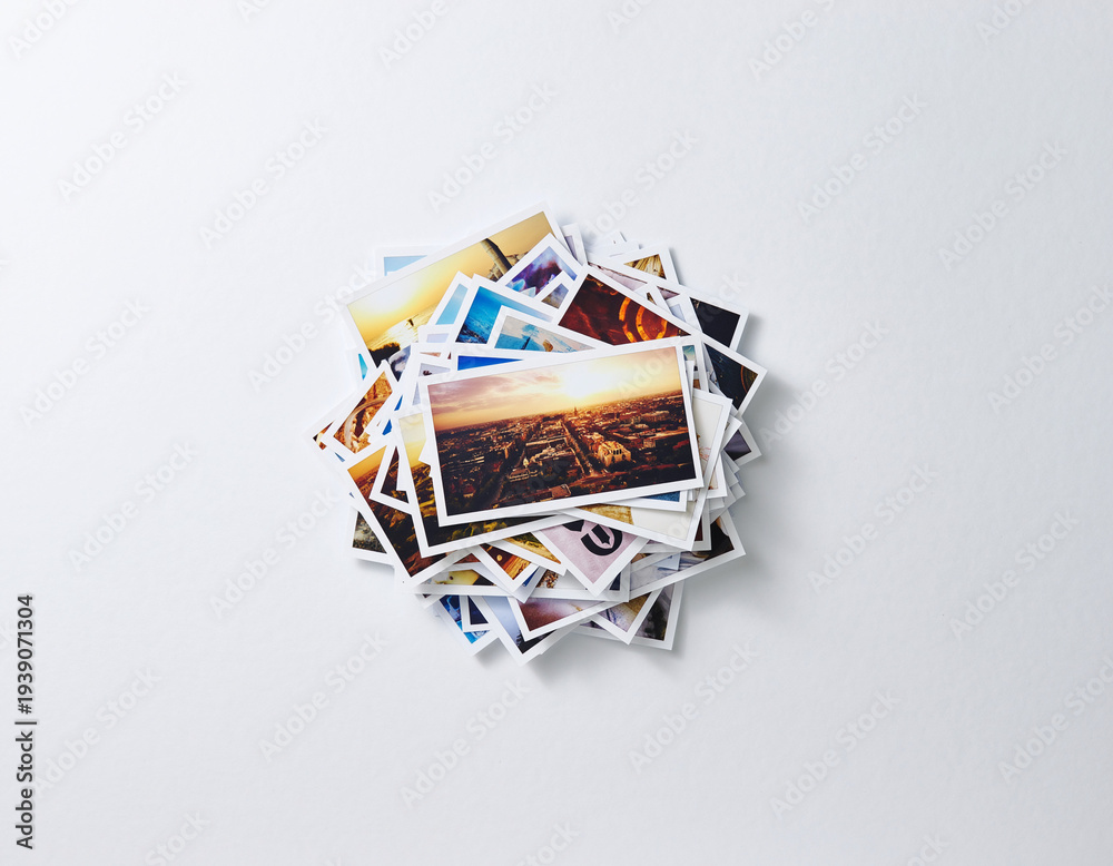 Fototapeta premium Stack of travel memories photos on white background 