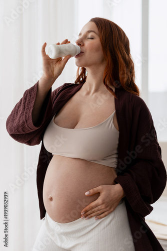 Pregnant woman drinking yogurt for healthy nutrition and maternal care