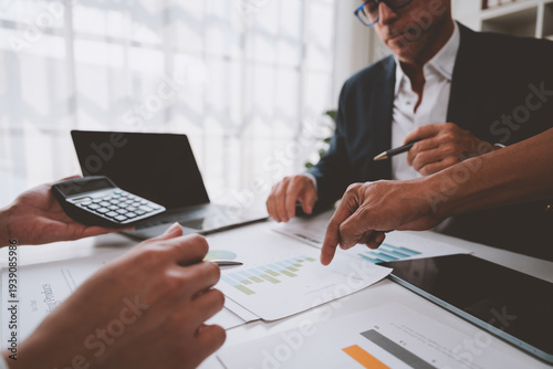 Business professionals analyzing financial reports during a meeting