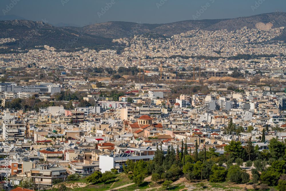 Obraz premium Wide view of Athens spreading across the Attica basin, seen from a hill overlooking the historic city