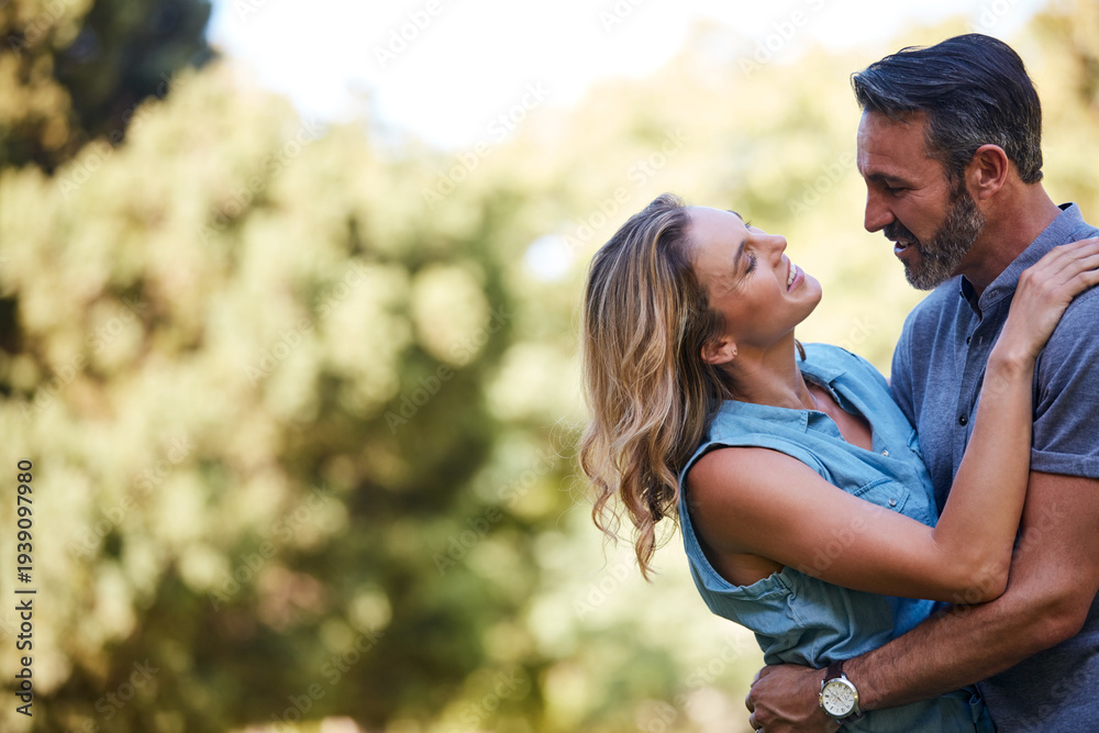 Fototapeta premium Happy, hug and couple in nature for bonding, care and love in marriage at park by space. Smile, outdoor and man embracing woman for trust, safety and connection in relationship at countryside.