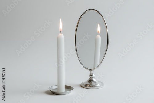 taper candle and mirror reflection creating dual flame effect