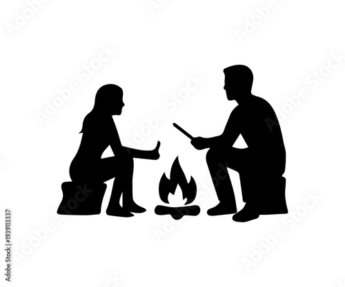 Couple sitting around a campfire at night silhouette
