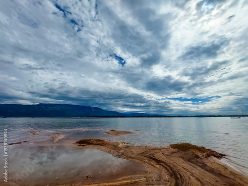 Tranquil River Under Cloudy Sky