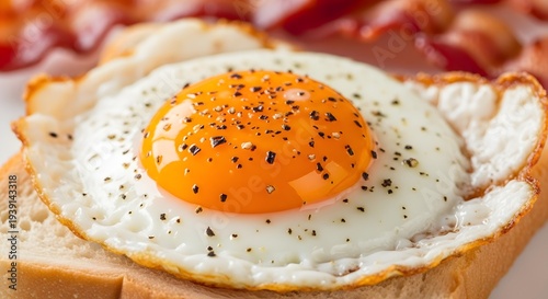 fried egg on a plate, Extreme close-up macro photo of a sunny side up fried egg on a slice of toasted white bread with crispy bacon in the background, bright orange egg yolk with cracked glossy surfac