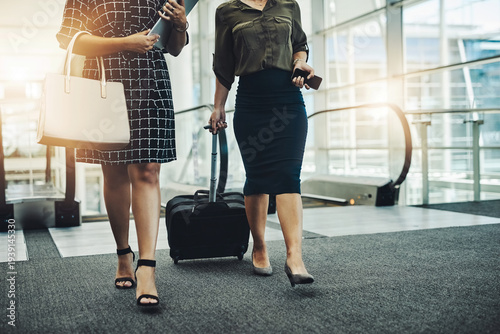 Business women, escalator and travel with suitcase in airport for convention, seminar or partnership. Female people, legs and luggage for flight, hotel or corporate trip for international industry