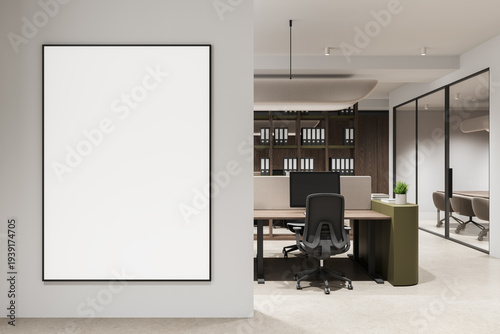Large empty poster mockup on a clean interior wall next to a modern office workspace layout and contemporary design backdrop.."" 3D Rendering