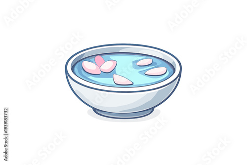 Bowl with water and floating flower petals placed on a table indoors