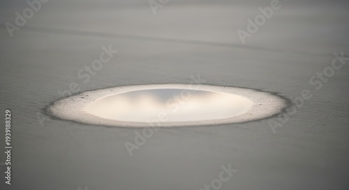 Small water puddle on fresh concrete background with reflective mood