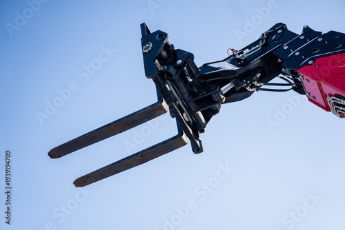 Obraz na plátně Telescopic handler or boom lift forks in the air, metal pallet forks and hydraul